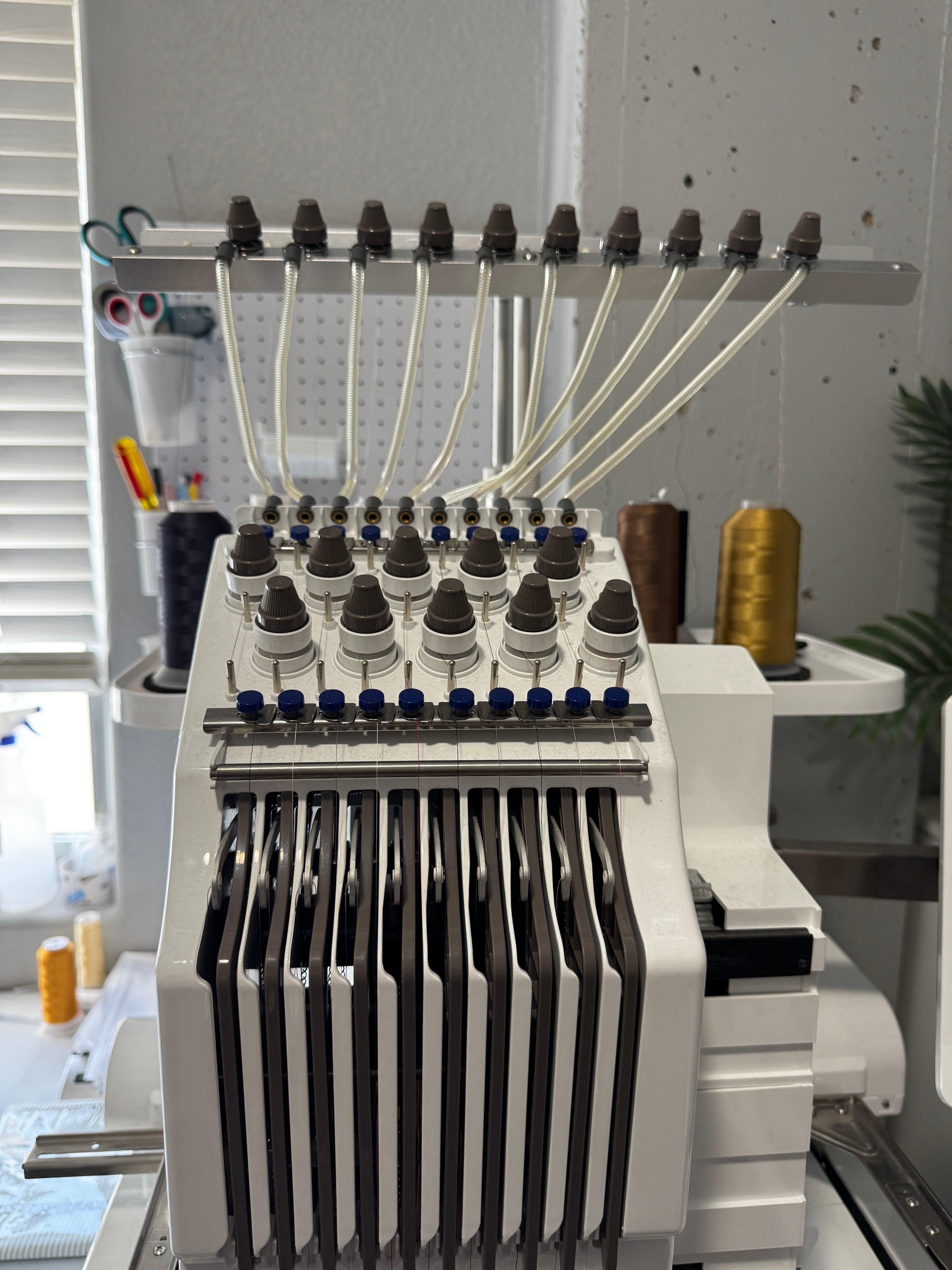 Close-up of a machine component with multiple nozzles and a metallic finish.